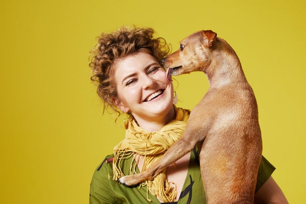woman holding dog smiling
